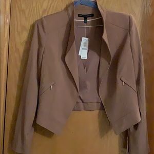 Tan jacket with gold hardware detail.